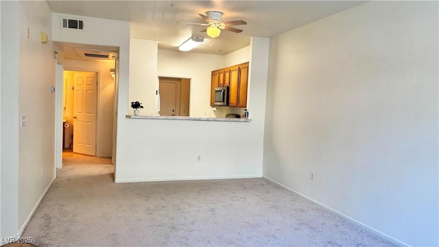 7163 S Durango Dr Unit 113, Las Vegas, NV 89113 - unfurnished living room with light colored carpet and ceiling fan