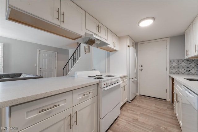 1407 Dorothy Ave Unit 2, Las Vegas, NV 89119 - kitchen featuring white appliances, under cabinet range hood, white cabinets, and light wood-style flooring