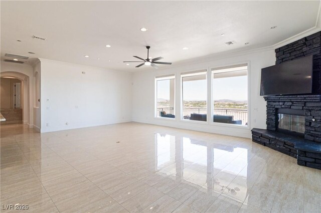 1319 Red Baron Ln, Boulder City, NV 89005 - unfurnished living room featuring arched walkways, ornamental molding, ceiling fan, light tile patterned flooring, and a stone fireplace