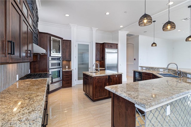 1319 Red Baron Ln, Boulder City, NV 89005 - kitchen featuring a spacious island, beverage cooler, stainless steel appliances, a warming drawer, and extractor fan