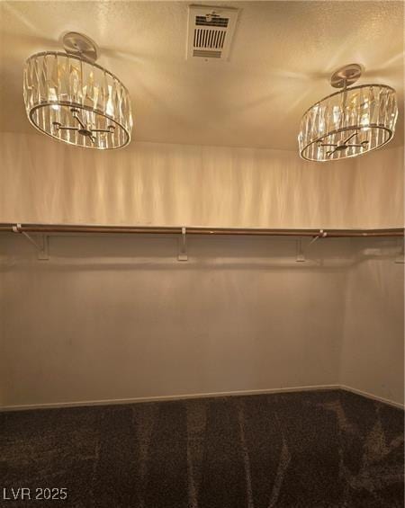 5121 Backwoodsman Ave, Las Vegas, NV 89130 - walk in closet featuring carpet floors and a chandelier
