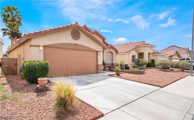 5121 Backwoodsman Ave, Las Vegas, NV 89130 - mediterranean / spanish-style home with stucco siding, a garage, a tiled roof, and driveway