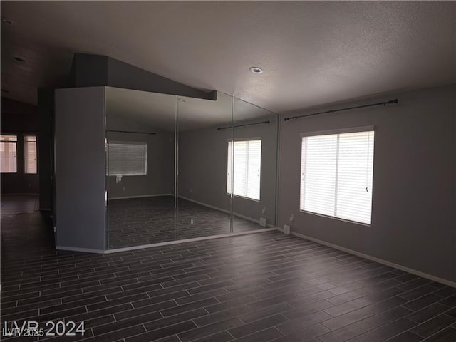 5121 Backwoodsman Ave, Las Vegas, NV 89130 - spare room with dark wood-style floors and vaulted ceiling