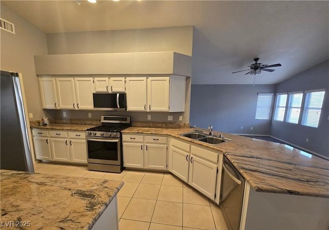 5121 Backwoodsman Ave, Las Vegas, NV 89130 - kitchen featuring stainless steel appliances, a peninsula, lofted ceiling, light tile patterned floors, and a ceiling fan