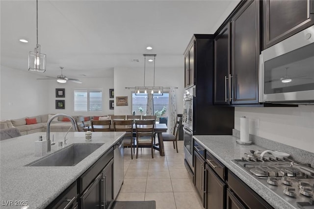 10181 Mount Harlow Ct, Las Vegas, NV 89141 - kitchen with stainless steel appliances, open floor plan, recessed lighting, ceiling fan, and hanging light fixtures