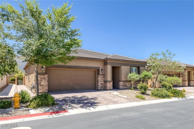 10181 Mount Harlow Ct, Las Vegas, NV 89141 - view of front of home with stone siding, a garage, driveway, and stucco siding