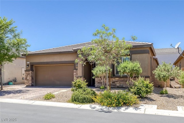 10181 Mount Harlow Ct, Las Vegas, NV 89141 - view of front of home with an attached garage, driveway, stone siding, and stucco siding