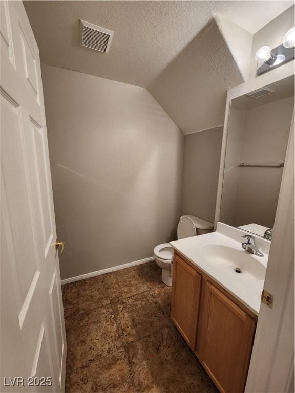 10231 Deerfield Beach Ave Unit 104, Las Vegas, NV 89129 - half bathroom with vanity, a textured ceiling, and lofted ceiling