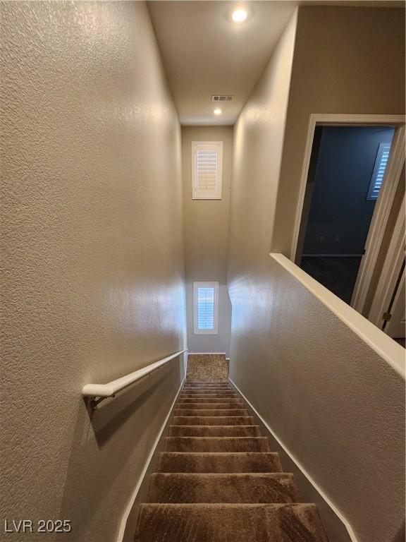 10231 Deerfield Beach Ave Unit 104, Las Vegas, NV 89129 - staircase with a textured wall and recessed lighting
