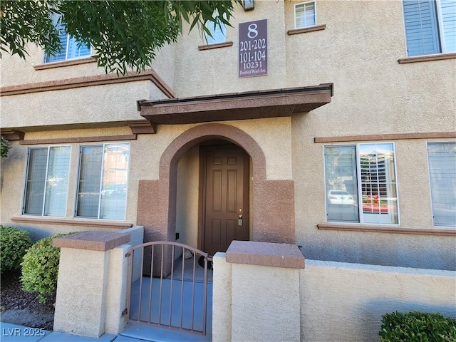 10231 Deerfield Beach Ave Unit 104, Las Vegas, NV 89129 - entrance to property featuring stucco siding and a gate