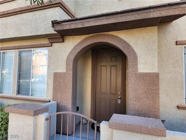 10231 Deerfield Beach Ave Unit 104, Las Vegas, NV 89129 - doorway to property with stucco siding