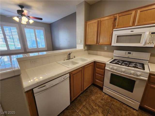 10231 Deerfield Beach Ave Unit 104, Las Vegas, NV 89129 - kitchen featuring white appliances, tile countertops, ceiling fan, and a peninsula