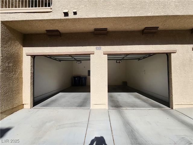 10231 Deerfield Beach Ave Unit 104, Las Vegas, NV 89129 - garage featuring driveway and a garage door opener
