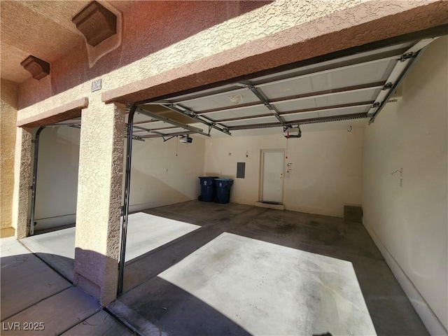 10231 Deerfield Beach Ave Unit 104, Las Vegas, NV 89129 - garage featuring a garage door opener and electric panel