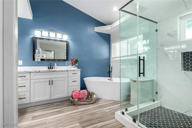7135 Polaris Ave, Las Vegas, NV 89118 - full bathroom with vanity, a shower stall, and a soaking tub