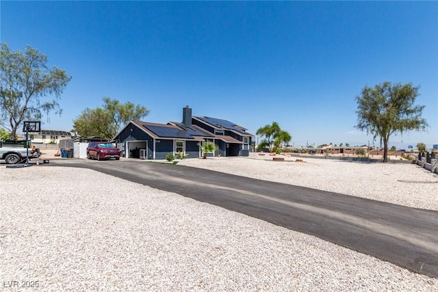 7135 Polaris Ave, Las Vegas, NV 89118 - view of front of house with solar panels and an attached garage