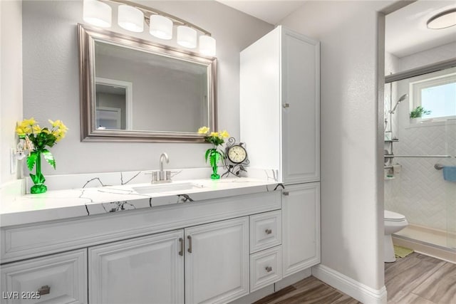 7135 Polaris Ave, Las Vegas, NV 89118 - bathroom featuring a shower stall, vanity, and wood finished floors