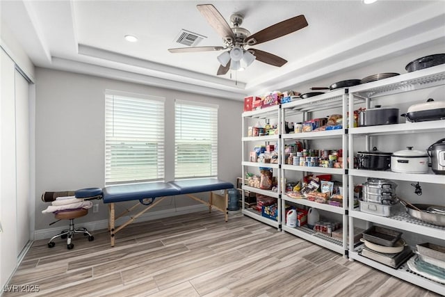 7135 Polaris Ave, Las Vegas, NV 89118 - home office featuring a raised ceiling, wood finished floors, ceiling fan, and recessed lighting