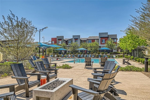3194 Lumassina Way, Henderson, NV 89044 - view of patio / terrace with a community pool and a fire pit