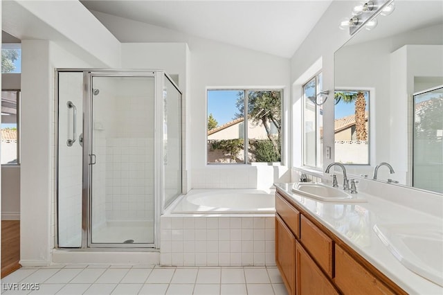 1908 Summit Pointe Dr, Las Vegas, NV 89117 - full bathroom with lofted ceiling, tile patterned flooring, a shower stall, a garden tub, and double vanity