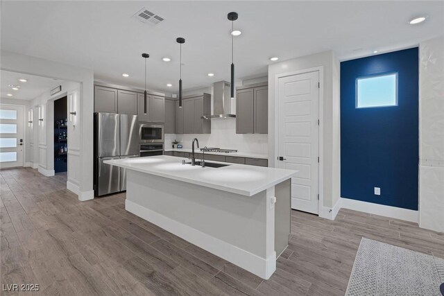 9617 Sard Ln, Las Vegas, NV 89143 - kitchen with wall chimney exhaust hood, gray cabinetry, stainless steel appliances, healthy amount of natural light, and recessed lighting