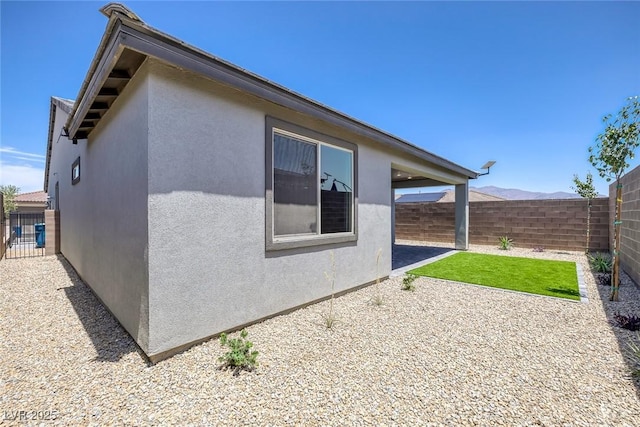 9617 Sard Ln, Las Vegas, NV 89143 - view of property exterior with a fenced backyard, stucco siding, and a patio area