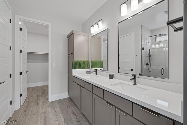 9617 Sard Ln, Las Vegas, NV 89143 - bathroom with double vanity, a stall shower, wood finished floors, and a spacious closet