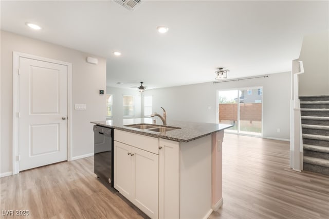 1102 E Dorrell Ln, North Las Vegas, NV 89086 - kitchen featuring dishwasher, light wood finished floors, open floor plan, dark stone counters, and recessed lighting