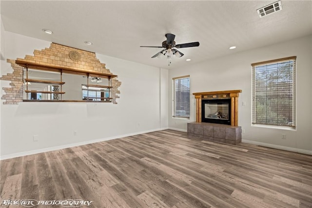 920 Vista Del Sol Ct, Mesquite, NV 89027 - unfurnished living room featuring wood finished floors, a ceiling fan, a fireplace, and recessed lighting
