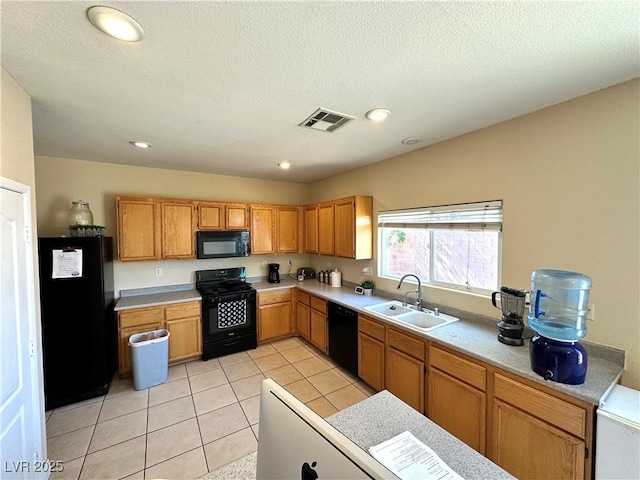 9148 Patrick Henry Ave, Las Vegas, NV 89149 - kitchen featuring black appliances, light countertops, recessed lighting, a textured ceiling, and light tile patterned floors