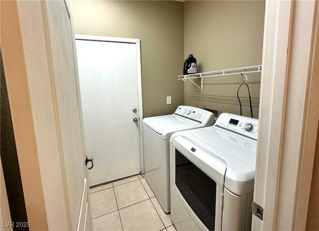 9148 Patrick Henry Ave, Las Vegas, NV 89149 - laundry room with washer and clothes dryer and light tile patterned floors