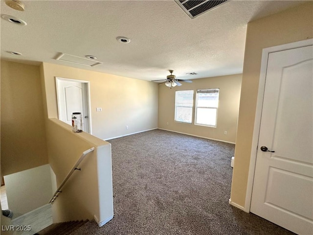 9148 Patrick Henry Ave, Las Vegas, NV 89149 - unfurnished room featuring dark colored carpet, a ceiling fan, a textured ceiling, and attic access
