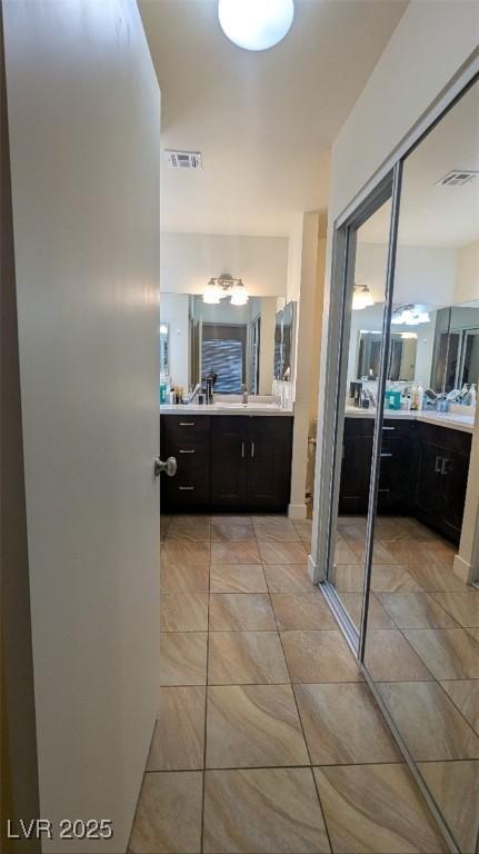4877 S Torrey Pines Dr Unit 104, Las Vegas, NV 89103 - full bathroom featuring two vanities