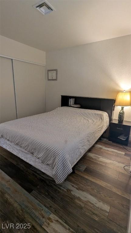 4877 S Torrey Pines Dr Unit 104, Las Vegas, NV 89103 - bedroom featuring wood finished floors and a closet