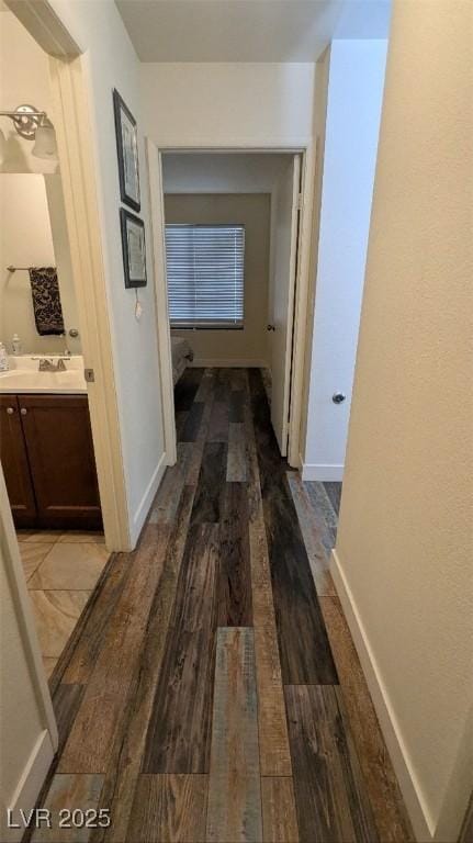 4877 S Torrey Pines Dr Unit 104, Las Vegas, NV 89103 - hallway with wood finished floors and baseboards