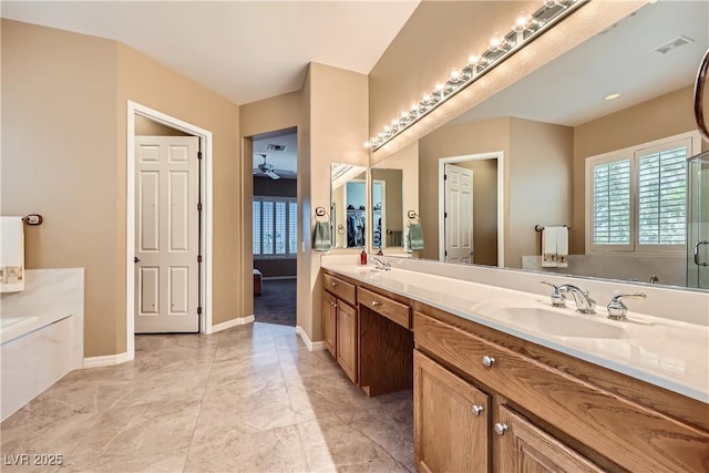 1637 Wellington Springs Ave, Henderson, NV 89052 - full bath featuring a garden tub, plenty of natural light, double vanity, and a ceiling fan