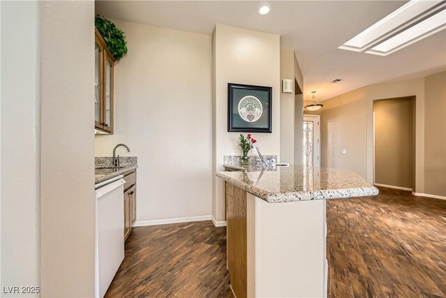 1637 Wellington Springs Ave, Henderson, NV 89052 - kitchen featuring dishwasher, a peninsula, dark wood-style flooring, glass insert cabinets, and light stone countertops