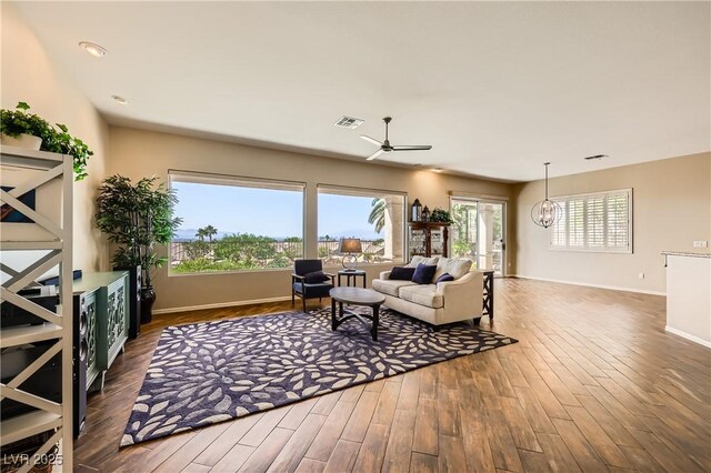 1637 Wellington Springs Ave, Henderson, NV 89052 - living area featuring ceiling fan, wood finished floors, and a chandelier