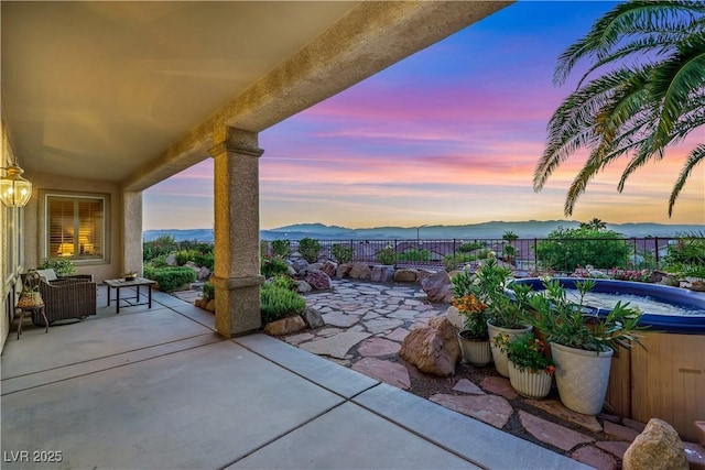 1637 Wellington Springs Ave, Henderson, NV 89052 - patio terrace at dusk with a patio, a fenced backyard, and a mountain view