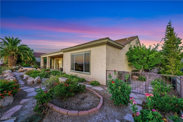 1637 Wellington Springs Ave, Henderson, NV 89052 - back of property at dusk featuring stucco siding