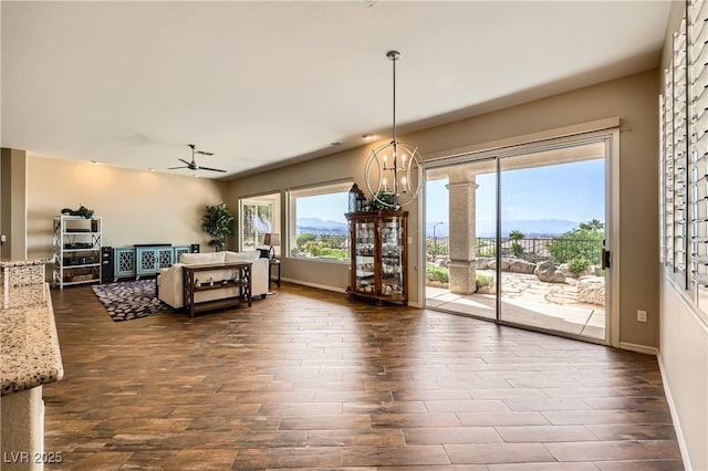 1637 Wellington Springs Ave, Henderson, NV 89052 - living area with dark wood-type flooring, ceiling fan, and a chandelier