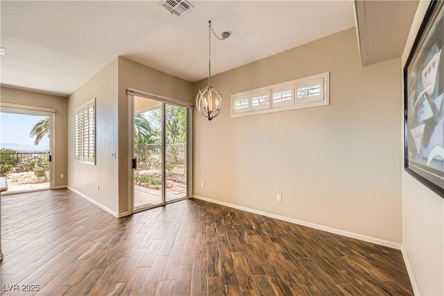 1637 Wellington Springs Ave, Henderson, NV 89052 - unfurnished dining area featuring dark wood finished floors and a chandelier