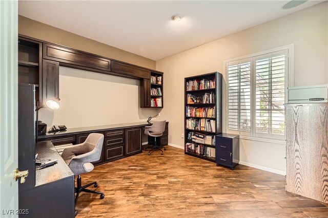 1637 Wellington Springs Ave, Henderson, NV 89052 - home office featuring wood finished floors and built in study area