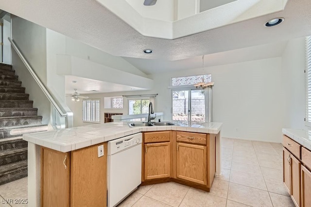 1547 Balsam Mist Ave, Las Vegas, NV 89183 - kitchen featuring dishwasher, ceiling fan, a chandelier, vaulted ceiling, and light tile patterned floors