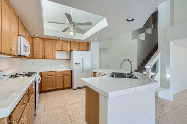 1547 Balsam Mist Ave, Las Vegas, NV 89183 - kitchen with white appliances, tile counters, ceiling fan, a tray ceiling, and recessed lighting