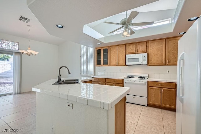 1547 Balsam Mist Ave, Las Vegas, NV 89183 - kitchen featuring white appliances, tile counters, brown cabinets, and recessed lighting