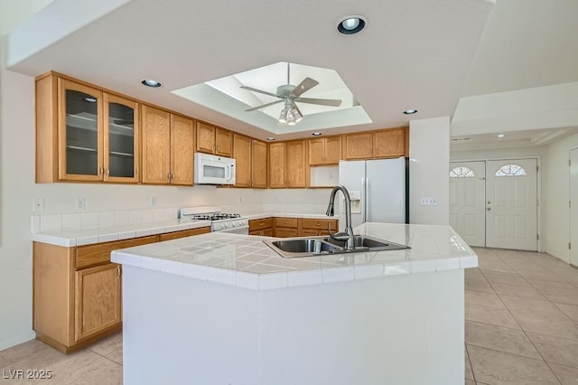 1547 Balsam Mist Ave, Las Vegas, NV 89183 - kitchen with white appliances, a raised ceiling, light tile patterned floors, ceiling fan, and recessed lighting