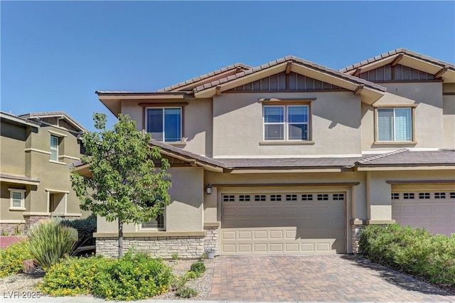 10360 Pescado Ln, Las Vegas, NV 89135 - view of front of home with stone siding, a garage, a tile roof, and stucco siding