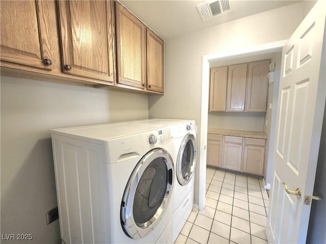 8220 Desert Beach Dr, Las Vegas, NV 89128 - washroom with washing machine and clothes dryer, cabinet space, and light tile patterned flooring