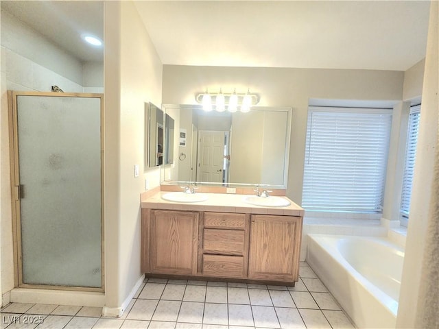 8220 Desert Beach Dr, Las Vegas, NV 89128 - bathroom featuring tile patterned floors, a shower stall, double vanity, and a garden tub